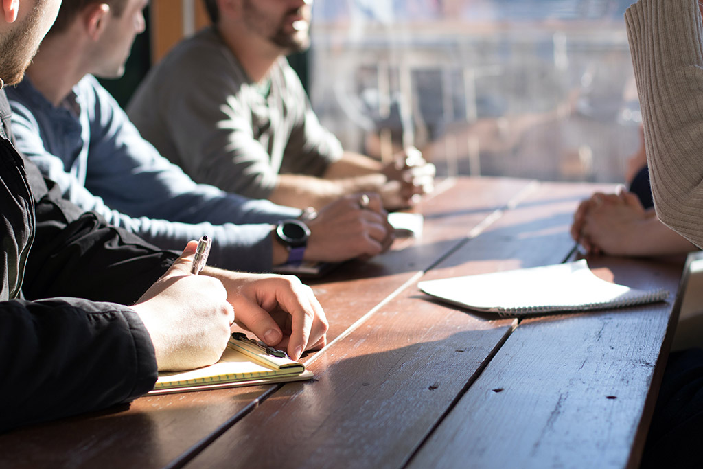 A team having a meeting on a long table for an effective decision-making in business